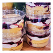 Stacks of trifles in individual plastic containers.